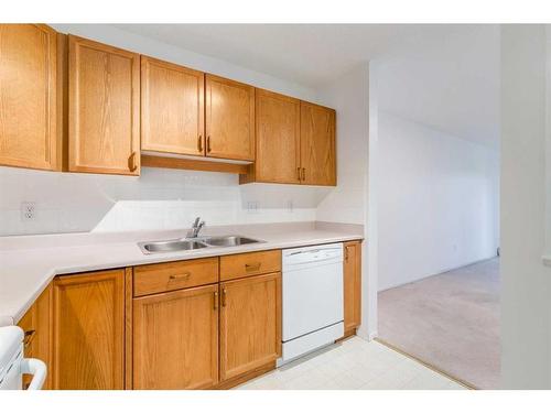 3309-3000 Sienna Park Green Sw, Calgary, AB - Indoor Photo Showing Kitchen With Double Sink