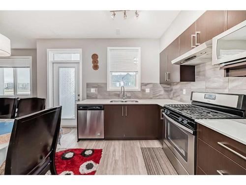 202-515 Redstone Walk Ne, Calgary, AB - Indoor Photo Showing Kitchen With Stainless Steel Kitchen With Double Sink