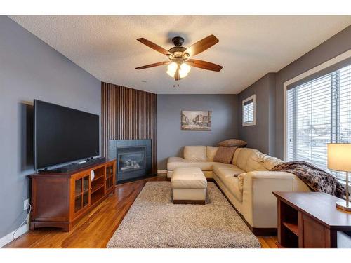 225 Cougar Ridge Drive Sw, Calgary, AB - Indoor Photo Showing Living Room With Fireplace