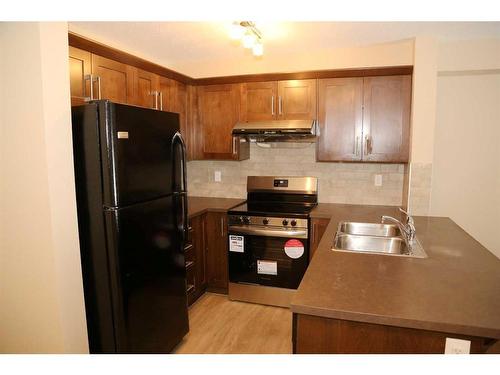 1117-130 Panatella Street Nw, Calgary, AB - Indoor Photo Showing Kitchen With Double Sink