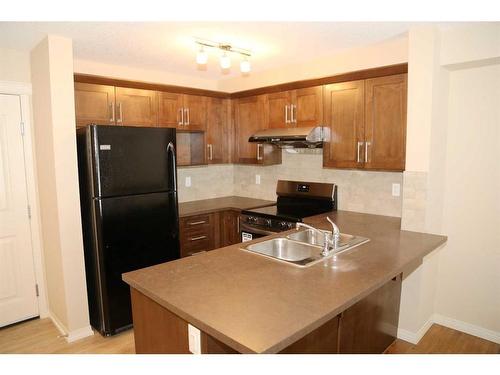 1117-130 Panatella Street Nw, Calgary, AB - Indoor Photo Showing Kitchen With Double Sink