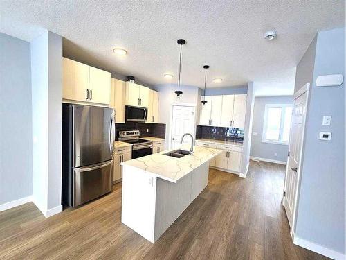 1927 Mccaskill Drive, Crossfield, AB - Indoor Photo Showing Kitchen With Double Sink With Upgraded Kitchen