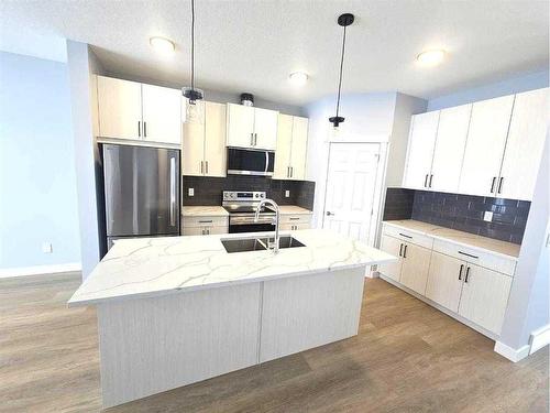 1927 Mccaskill Drive, Crossfield, AB - Indoor Photo Showing Kitchen With Double Sink With Upgraded Kitchen