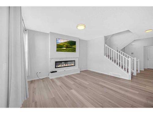 94 Belmont Crescent Sw, Calgary, AB - Indoor Photo Showing Other Room With Fireplace