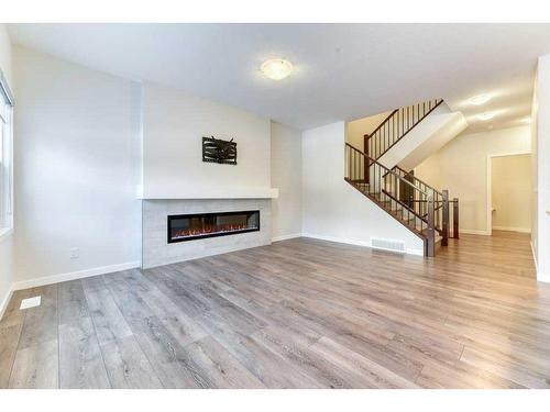 81 Legacy Reach Crescent Se, Calgary, AB - Indoor Photo Showing Living Room With Fireplace