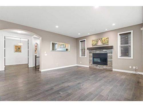 134 Rainbow Falls Blvd, Chestermere, AB - Indoor Photo Showing Living Room With Fireplace