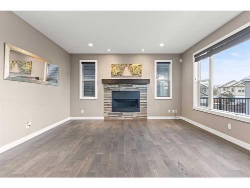 134 Rainbow Falls Blvd, Chestermere, AB - Indoor Photo Showing Living Room With Fireplace