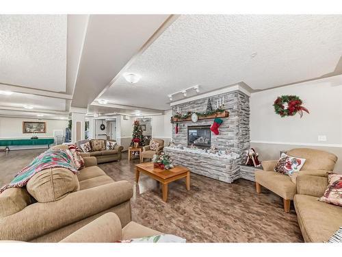 3106-3000 Millrise Point Sw, Calgary, AB - Indoor Photo Showing Living Room With Fireplace