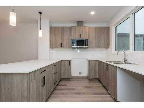 822 Creekside Boulevard Sw, Calgary, AB - Indoor Photo Showing Kitchen With Double Sink