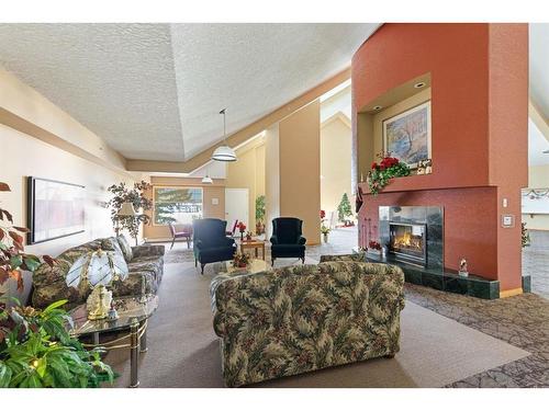 246-6868 Sierra Morena Boulevard Sw, Calgary, AB - Indoor Photo Showing Living Room With Fireplace