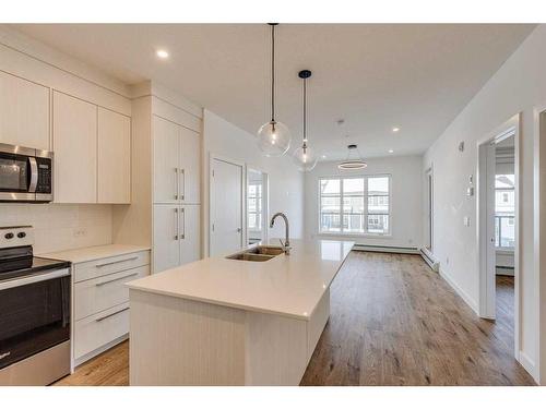 1216-681 Savanna Boulevard Ne, Calgary, AB - Indoor Photo Showing Kitchen With Double Sink With Upgraded Kitchen