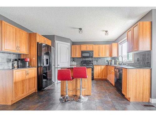 335 Saddlebrook Circle Ne, Calgary, AB - Indoor Photo Showing Kitchen With Double Sink