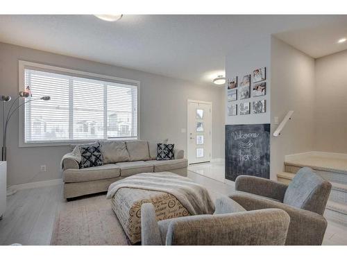 105 Chelsea Drive, Chestermere, AB - Indoor Photo Showing Living Room With Fireplace