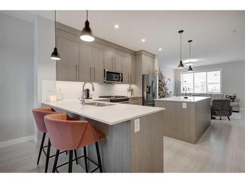 105 Chelsea Drive, Chestermere, AB - Indoor Photo Showing Kitchen With Double Sink With Upgraded Kitchen