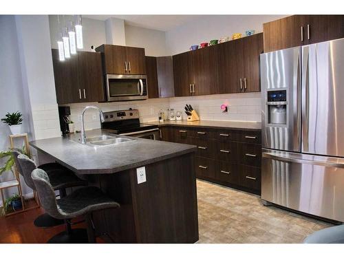 1210-10 Auburn Bay Avenue Se, Calgary, AB - Indoor Photo Showing Kitchen With Stainless Steel Kitchen With Double Sink