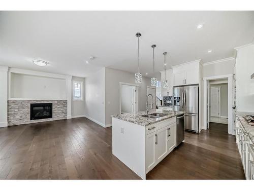 382 Kings Heights Drive Se, Airdrie, AB - Indoor Photo Showing Kitchen With Fireplace With Double Sink With Upgraded Kitchen