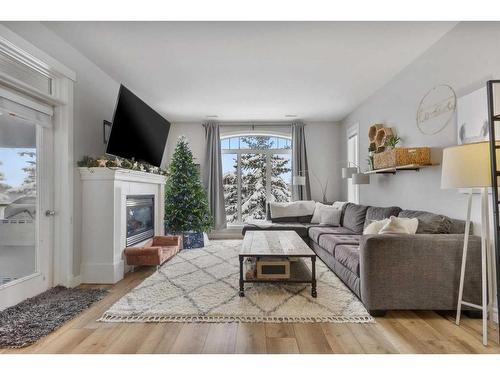 602-8000 Wentworth Drive Sw, Calgary, AB - Indoor Photo Showing Living Room With Fireplace