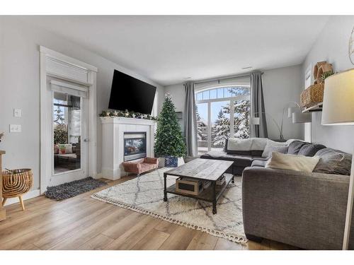 602-8000 Wentworth Drive Sw, Calgary, AB - Indoor Photo Showing Living Room With Fireplace