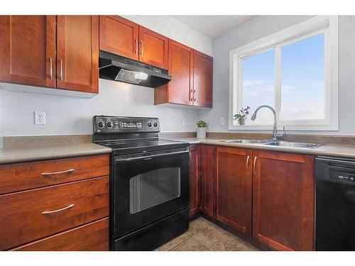 1350-2395 Eversyde Avenue Sw, Calgary, AB - Indoor Photo Showing Kitchen With Double Sink