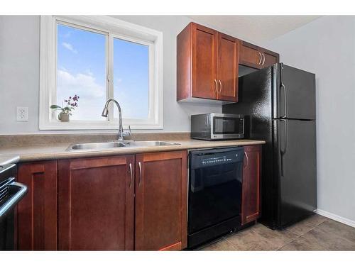 1350-2395 Eversyde Avenue Sw, Calgary, AB - Indoor Photo Showing Kitchen With Double Sink