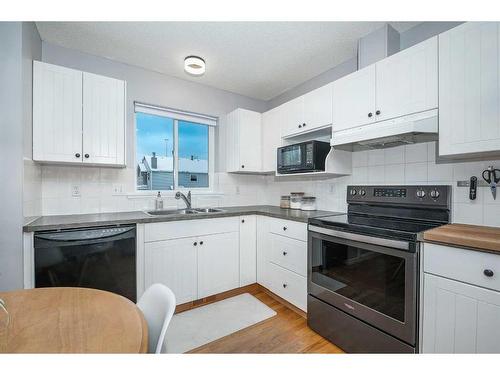 27 Mcdougall Court Ne, Calgary, AB - Indoor Photo Showing Kitchen With Double Sink