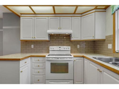 27-26 Quigley Drive, Cochrane, AB - Indoor Photo Showing Kitchen With Double Sink