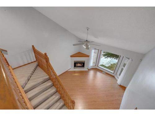 27-26 Quigley Drive, Cochrane, AB - Indoor With Fireplace