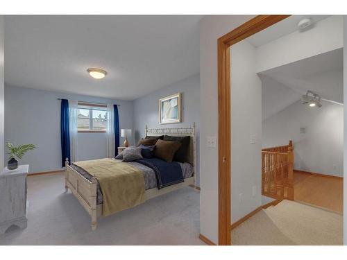 27-26 Quigley Drive, Cochrane, AB - Indoor Photo Showing Bedroom