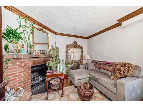 15-64 Woodacres Crescent Sw, Calgary, AB - Indoor Photo Showing Living Room With Fireplace