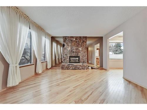 703 Ranchview Circle Nw, Calgary, AB - Indoor Photo Showing Living Room With Fireplace