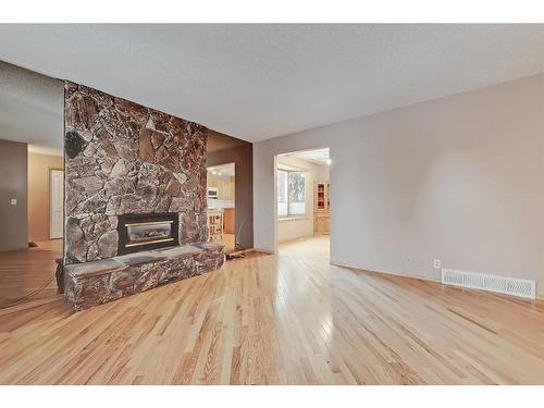 703 Ranchview Circle Nw, Calgary, AB - Indoor Photo Showing Living Room With Fireplace