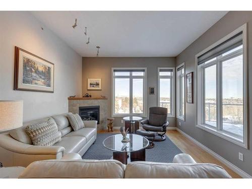 403-4 Hemlock Crescent Sw, Calgary, AB - Indoor Photo Showing Living Room With Fireplace