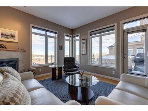 403-4 Hemlock Crescent Sw, Calgary, AB - Indoor Photo Showing Living Room With Fireplace