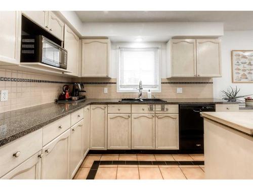 9-5790 Patina Drive Sw, Calgary, AB - Indoor Photo Showing Kitchen With Double Sink