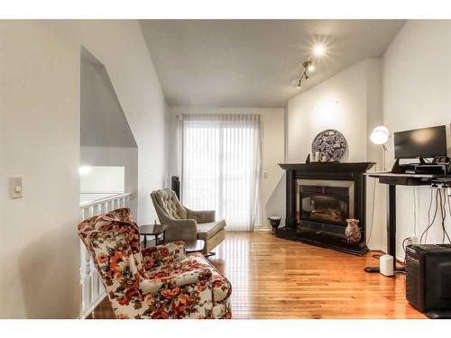 9-5790 Patina Drive Sw, Calgary, AB - Indoor Photo Showing Living Room With Fireplace