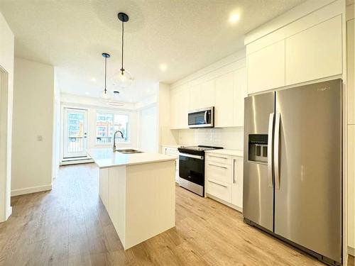 2101-111 Wolf Creek Drive Se, Calgary, AB - Indoor Photo Showing Kitchen With Stainless Steel Kitchen With Upgraded Kitchen