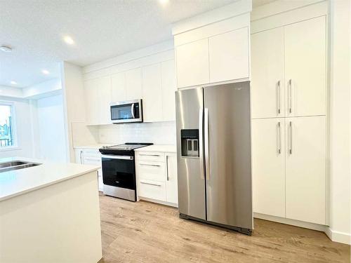 2101-111 Wolf Creek Drive Se, Calgary, AB - Indoor Photo Showing Kitchen With Stainless Steel Kitchen