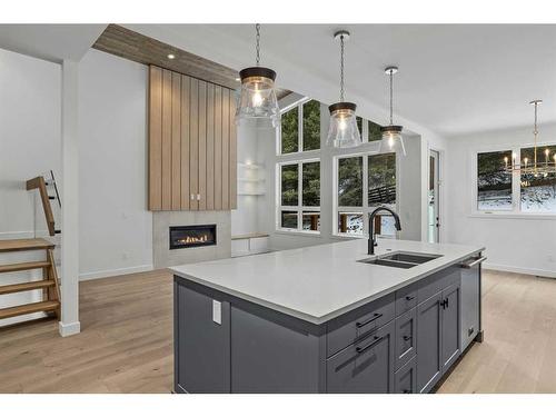 251A Three Sisters Drive, Canmore, AB - Indoor Photo Showing Kitchen With Fireplace With Double Sink