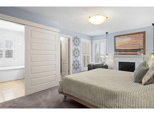 37 Wentworth Way Sw, Calgary, AB - Indoor Photo Showing Bedroom With Fireplace