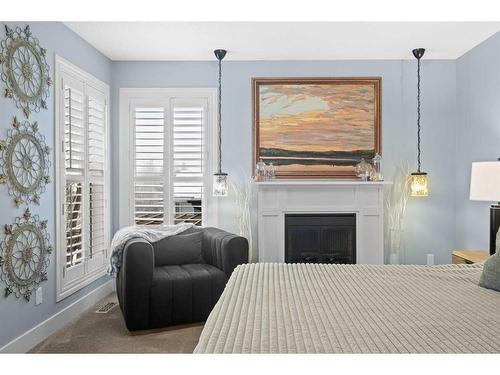 37 Wentworth Way Sw, Calgary, AB - Indoor Photo Showing Bedroom With Fireplace