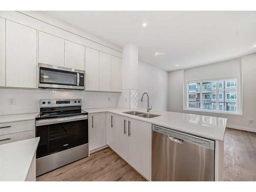 801-6 Merganser Drive West, Chestermere, AB - Indoor Photo Showing Kitchen With Stainless Steel Kitchen With Double Sink