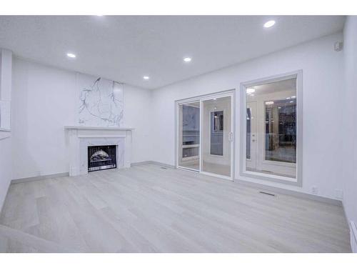 203 Cedarwood Road Sw, Calgary, AB - Indoor Photo Showing Living Room With Fireplace