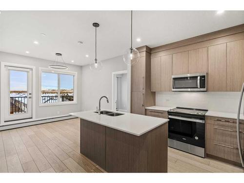 1410-111 Wolf Creek Drive Se, Calgary, AB - Indoor Photo Showing Kitchen With Double Sink