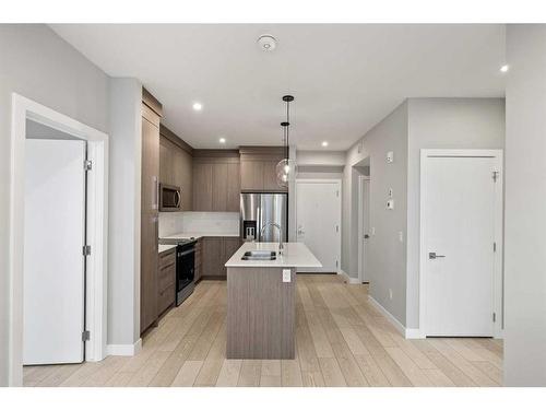 1410-111 Wolf Creek Drive Se, Calgary, AB - Indoor Photo Showing Kitchen With Double Sink