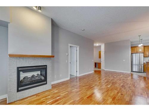 1407-24 Hemlock Crescent Sw, Calgary, AB - Indoor Photo Showing Living Room With Fireplace