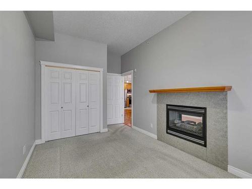 1407-24 Hemlock Crescent Sw, Calgary, AB - Indoor Photo Showing Living Room With Fireplace