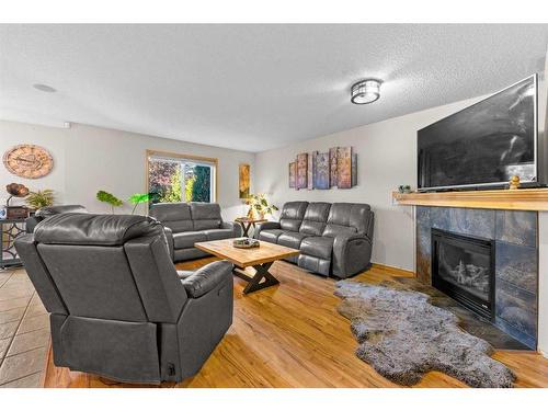 209 Tuscany Ravine Road Nw, Calgary, AB - Indoor Photo Showing Living Room With Fireplace