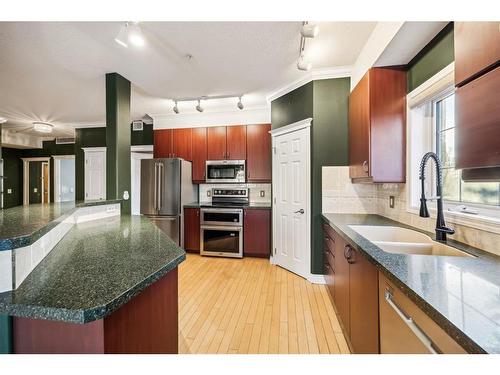 124-223 Tuscany Springs Boulevard Nw, Calgary, AB - Indoor Photo Showing Kitchen With Stainless Steel Kitchen With Double Sink With Upgraded Kitchen