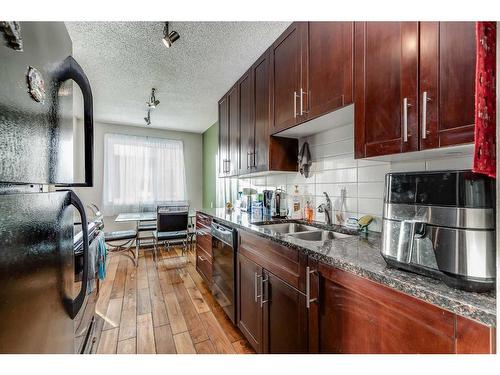 211-4455A Greenview Drive Ne, Calgary, AB - Indoor Photo Showing Kitchen With Double Sink