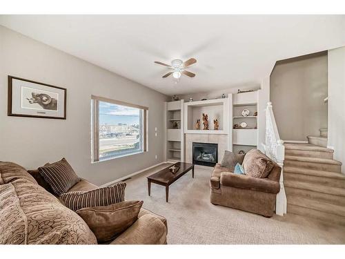 703-720 Willowbrook Road Nw, Airdrie, AB - Indoor Photo Showing Living Room With Fireplace